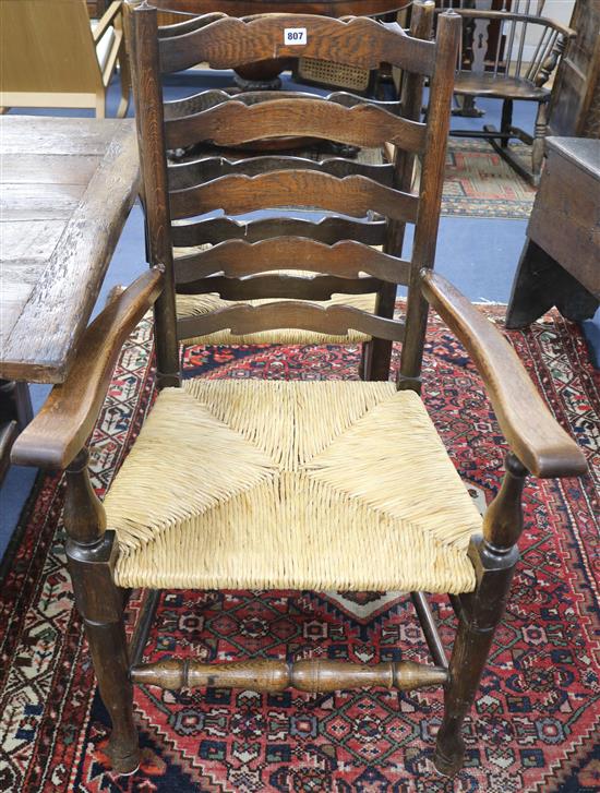 Eleven rush seat ladderback type chairs including two carvers